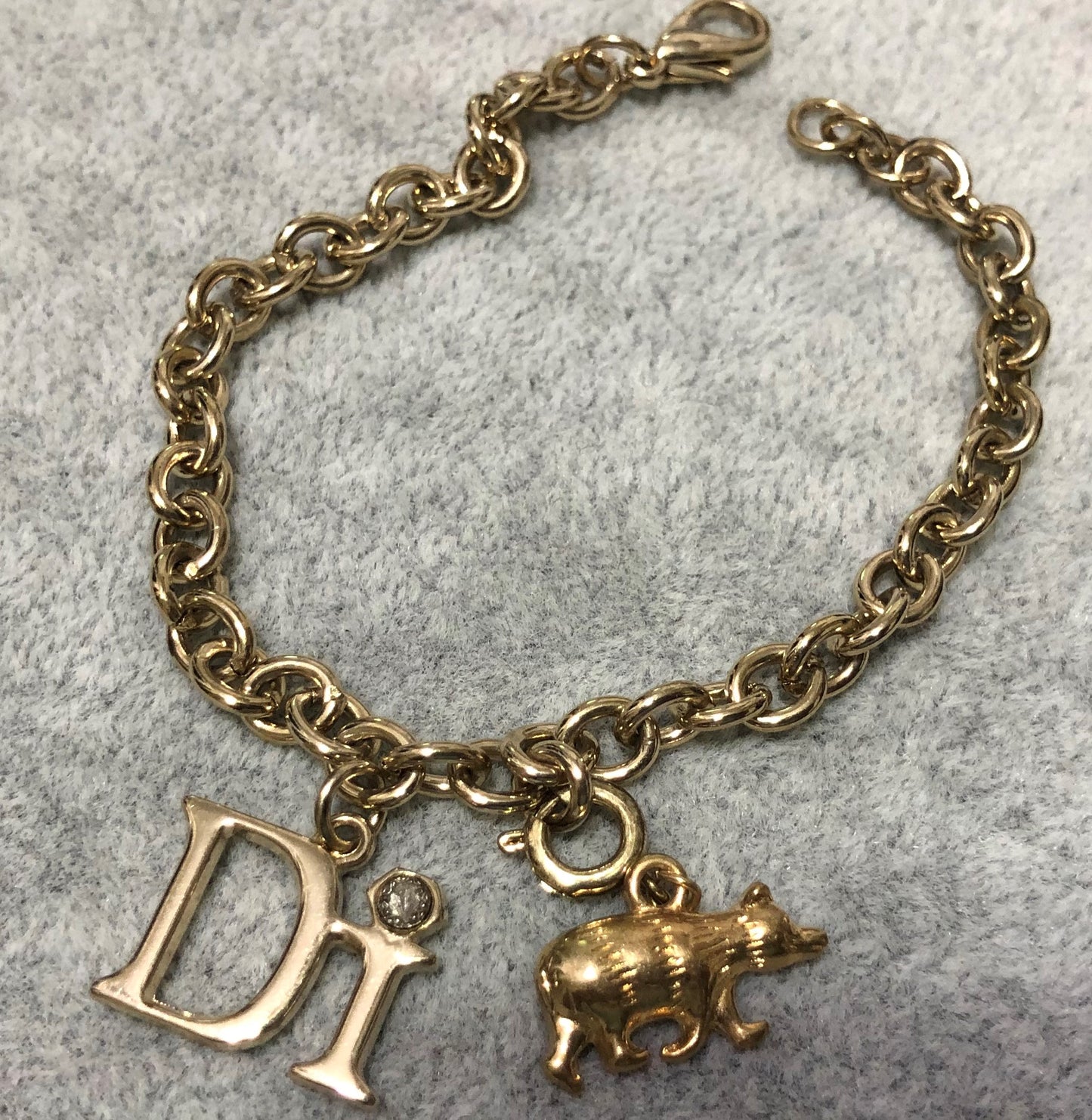 Diamonds International Charm Bracelet with a  Grizzly Bear and DI Charm